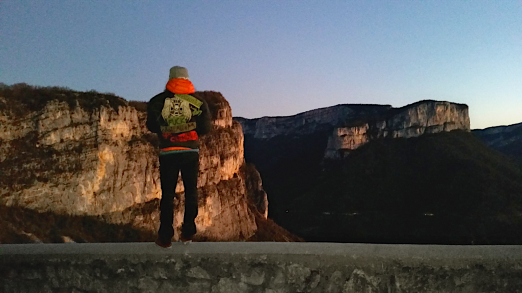 a person looking at rock walls in a valley in the evening sun